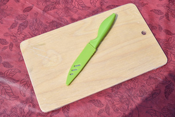 Kitchen cutting Board, on the table with a knife