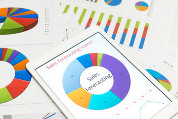 Financial charts on the table with tablet