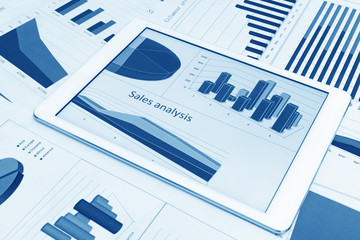 Financial charts on the table with tablet