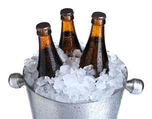 Beer in metal bucket with ice isolated on white