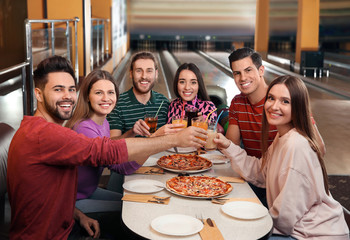 Poster - Group of friends with drinks and pizza in bowling club