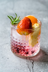 Wall Mural - Fruit Cocktail with Strawberry, Mandarin, Apple and Rosemary / Fresh Pink Punch Beverage.