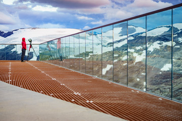 Wall Mural - Tourist with camera on tripod in Norway nature