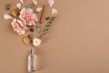 Flat Lay Composition With Bottle Of Perfume On Light Brown Background, Space For Text