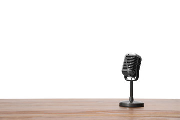 Vintage microphone on wooden table, space for text. Journalist's equipment