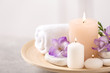 © New Africa - Beautiful composition with spa stones and burning candles on grey table