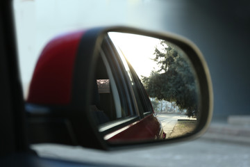 Side rear view mirror of modern car outdoors, closeup