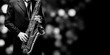 Playin' sax isolated at the left border of a black background (black and white)