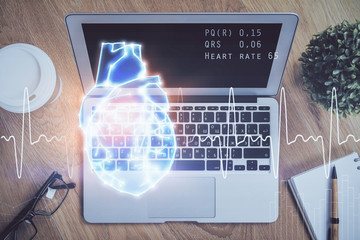 Desktop computer background and heart drawing. Double exposure. Medical study and healthcare concept.