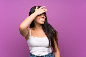 Wall Mural - Young teenager Asian girl over isolated purple background laughing