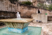 Beautiful Shot Of A Water Fountain With Cannon In The Background In Xativa, Spain