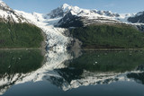 Fototapeta Krajobraz - Reflection In The Water Of High Snow Capped Mountain Range With Glacier At College Fjord, Alaska