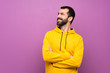 Handsome man with yellow sweatshirt happy and smiling