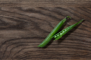 Fresh  pea pods on oak background. High resolution.