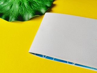 Wall Mural - notebook, pen, on yellow background.  top view copy space