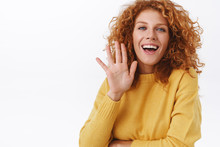 Waist-up Cheerful, Smiling Redhead Curly Woman Silly And Coquettish Grinning As Waving Her Palm, Greeting Friend, Say Hi Or Hello, Leave Party And Tell Everyone Goodbye Over White Background