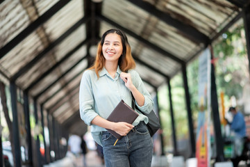 Wall Mural - Happy young Asian University student.