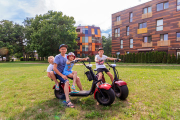 Palanga, Lithuania: Dad rolls children on electric scooter