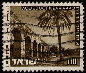 Wall Mural - ISRAEL - CIRCA 1973: stamp 1.1 Israeli lira printed by State of Israel, shows view of Aqueduct near Akko, bridge and palm tree, circa 1973