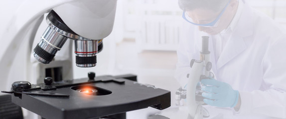 Wall Mural - laboratory concept; closed up picture of a microscope with blurred background of scientist research 
