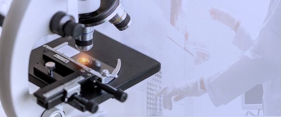 Wall Mural - close-up shot of microscope with the metal lens with blurred background of gc chromatography testing