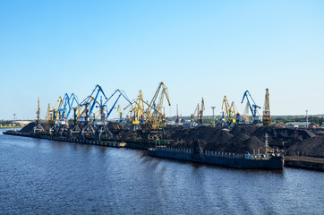 Baltic coal terminal with port cranes near the river. Riga cargo, Latvia