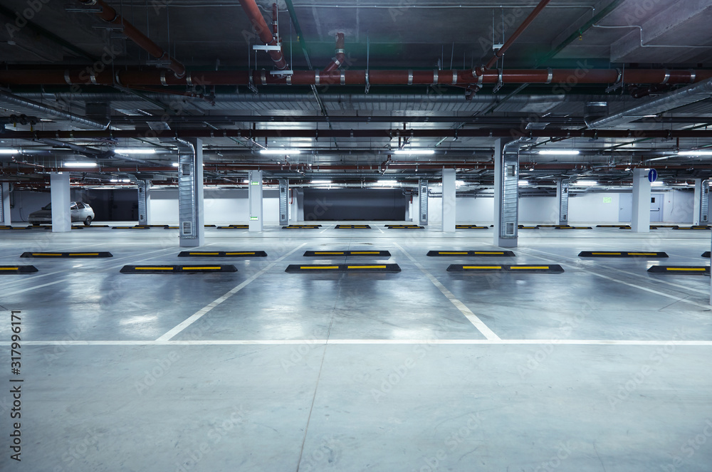 Horizontal image of empty underground parking lot - obrazy, fototapety, plakaty 