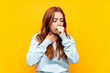 © luismolinero - Teenager redhead girl over isolated yellow background is suffering with cough and feeling bad