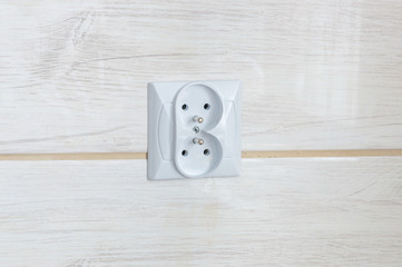 Electric socket type E on ceramic tiles.