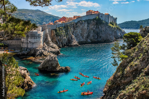 Dubrovnik West Harbor and the ancient city wall with sea kayaks in the foreground. Famous filming location, Croatia. Film location Game of Thrones.