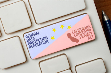 GDPR and CCPA concept: a white keyboard with a key with text general data protection regulation and california consumer privacy act. This two laws regulate data protection and privacy.