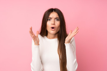 Wall Mural - Young woman over isolated pink background with surprise facial expression