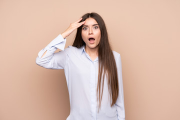 Wall Mural - Young woman over isolated background has just realized something and has intending the solution