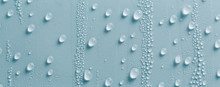 Full Frame Shot Of Raindrops On Blue Glass