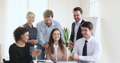 Sticker - Multiethnic business team congratulate happy female worker applaud in office