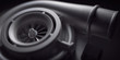 Car turbocharger on black background. Auto part turbo engine technology concept.