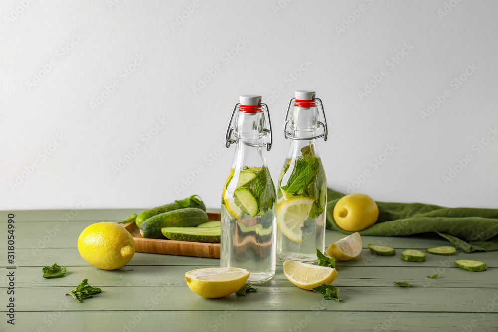 Bottles of healthy infused water on table