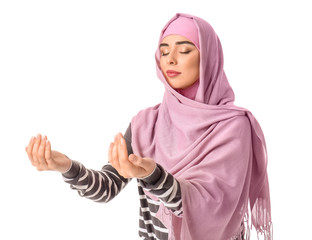 Wall Mural - Muslim woman praying against white background