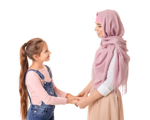 Wall Mural - Portrait of Muslim woman with daughter on white background