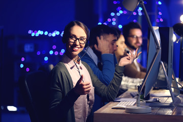 Poster - Technical support agents working in office at night