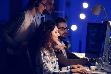 Poster - Technical support agents working in office at night