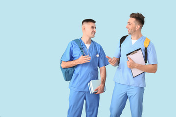 Sticker - Male medical students on color background