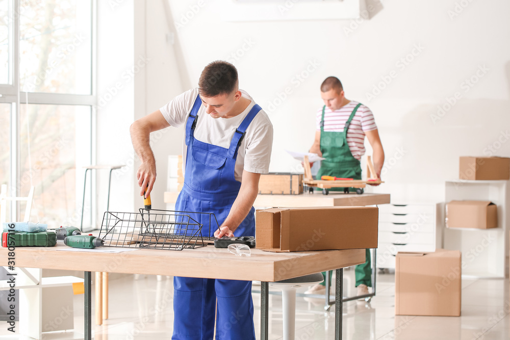 Handymen assembling furniture in workshop