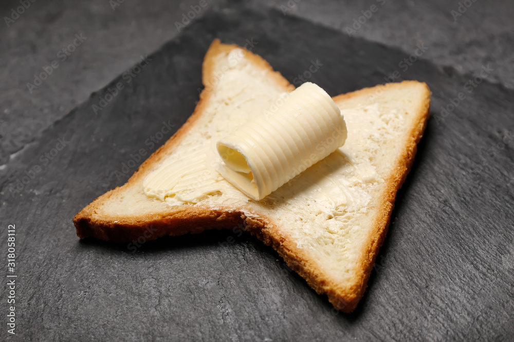 Slate plate with tasty bread and butter, closeup