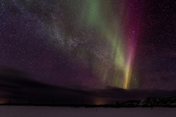 Northern lights ( Aurora Borealis ) over the Milky Way in Iceland