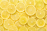 Fototapeta  - Fresh lemon slices pattern backgrond, close up