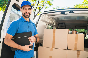 Delivery man checking the products with checklist.