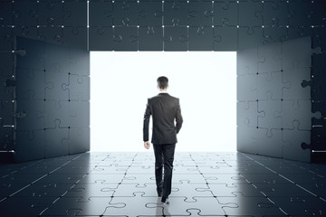 Poster - businessman looking out of window in abstract jigsaw interior