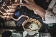 Close-Up Of Man Pouring Coffee In Cup