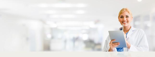 Doctor using tablet computer at the hospital. Medical healthcare and doctor staff service.